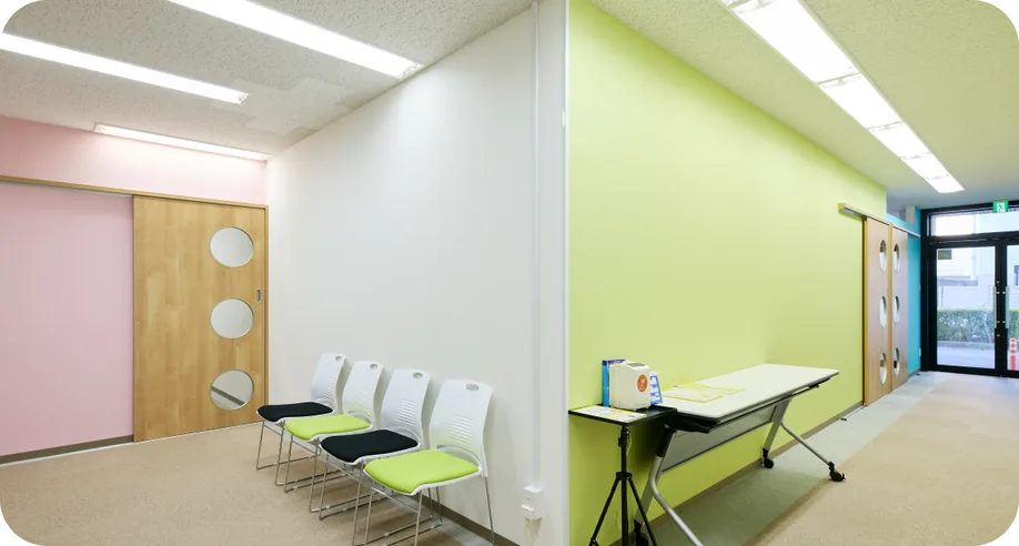 D.School 本校の教室(ピンクと黄緑の壁の明るい室内)